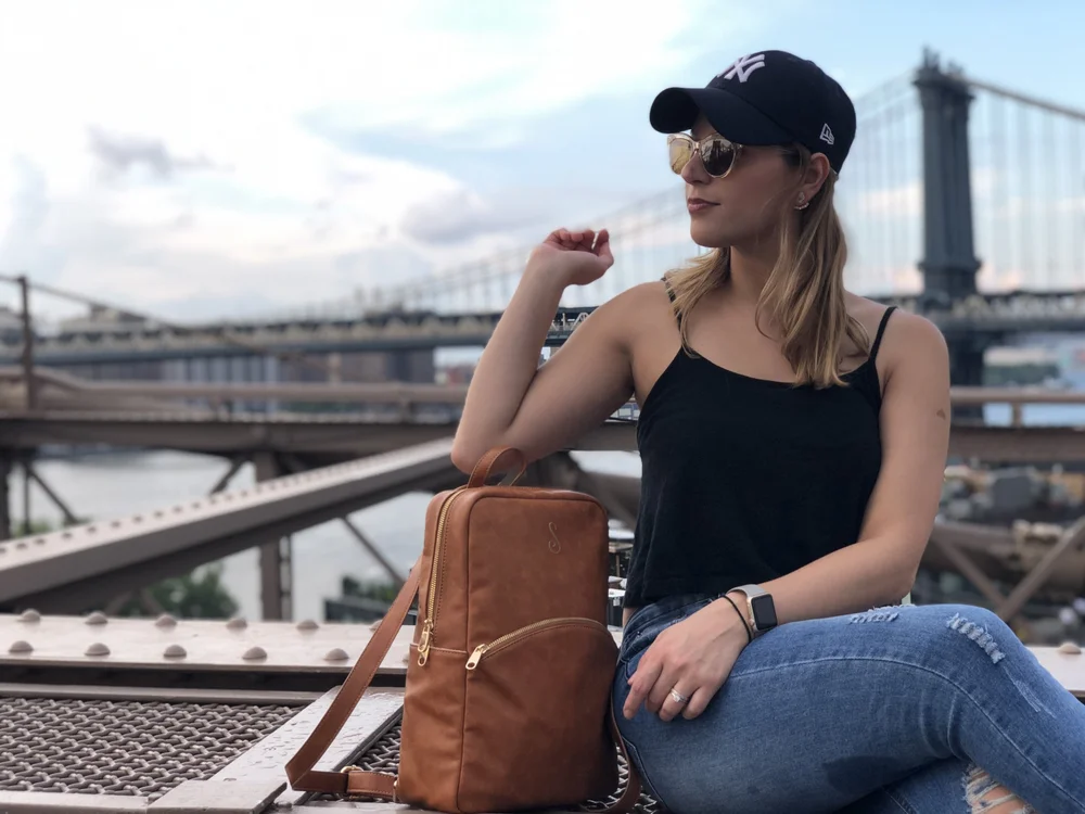 Sonia on the Brooklyn Bridge with a cognac Sosi Leone backpack